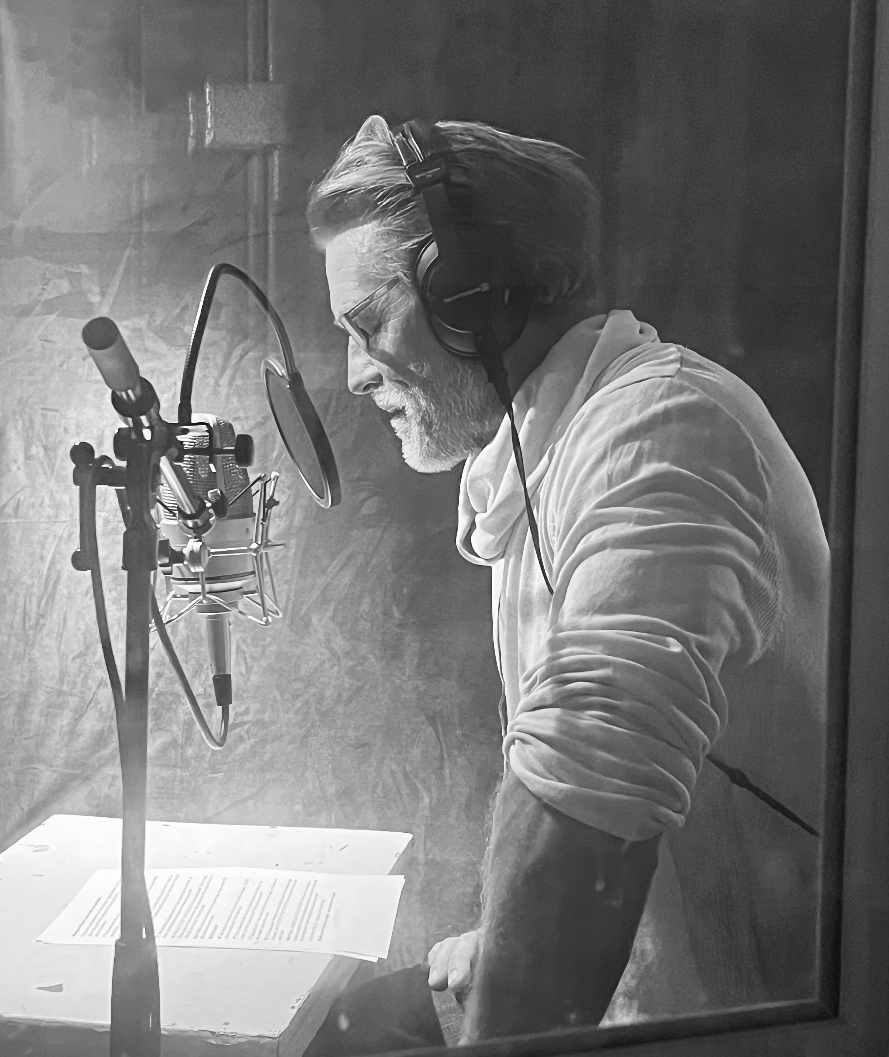 A voice actor recording in a studio